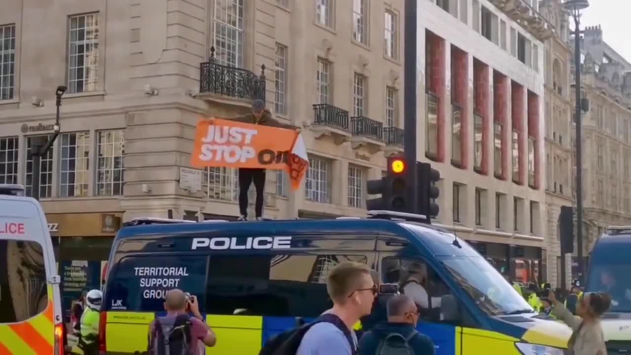 just stop oil supporter scales Metropolitan Police van, demands end to new oil a_1