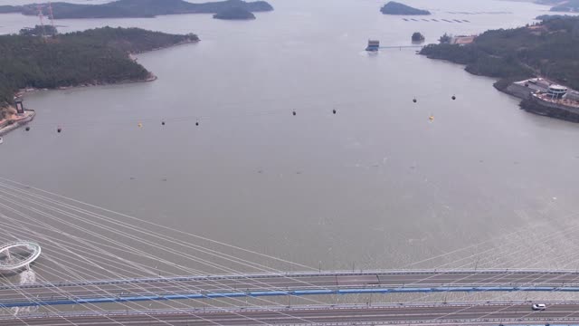 Time Lab drone view flying over the sea while looking at a cable car from