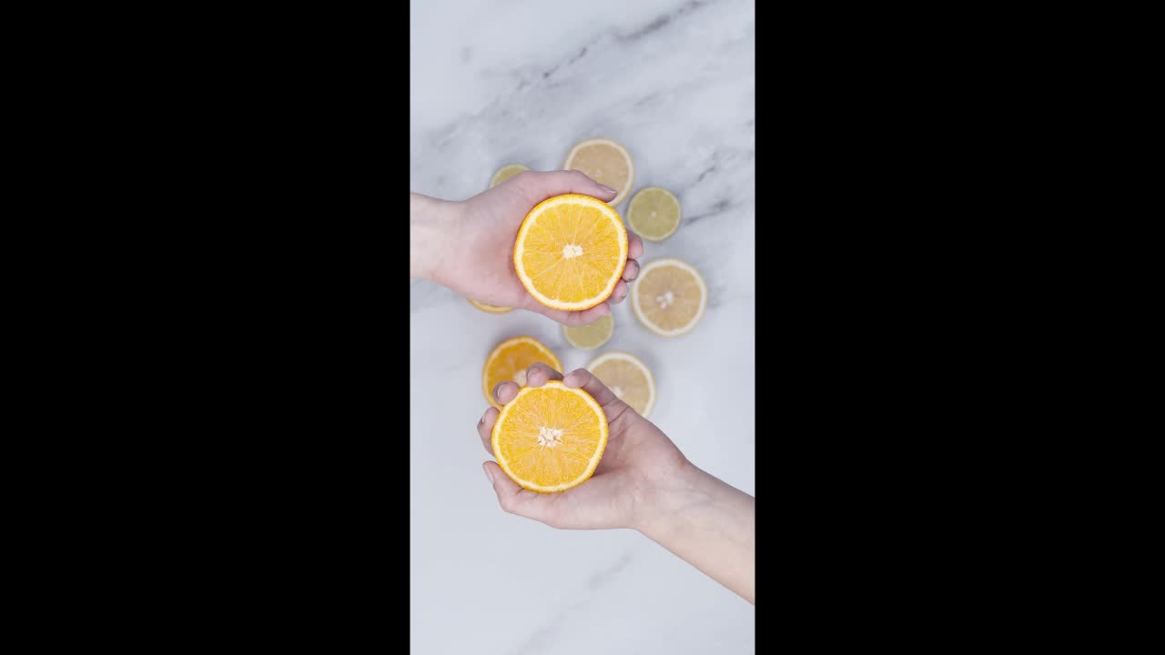 Squeezing By Hand The Slices Of Orange Fruits