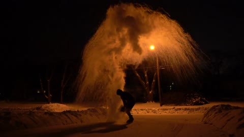 Guy Throwing Boiling Water Into the Air in -30 Degrees During the Night