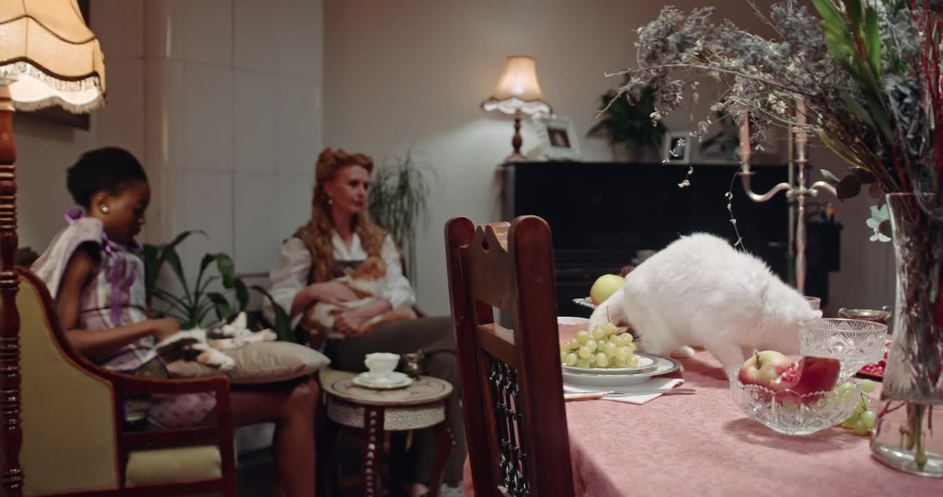 A Cat Licking The Crystal Glass On Top Of The Table