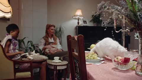 A Cat Licking The Crystal Glass On Top Of The Table