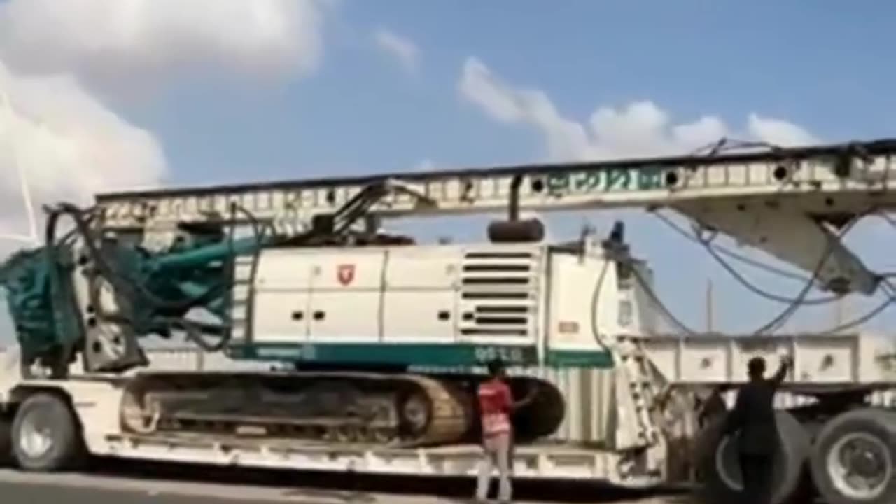 Heavy Hauler in Action: Massive Machinery Loaded onto Lowboy 🚛