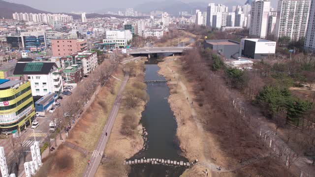 Time Labs drone view racing along the stream in the city