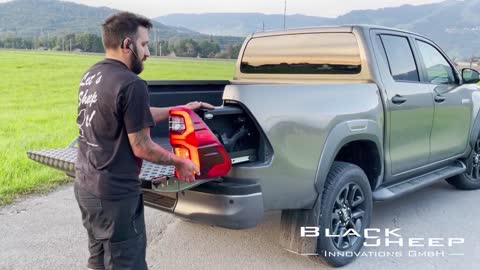 Toyota Hilux lockable, hidden (concealed) rearlight gun compartment by Black Sheep Innovations GmbH