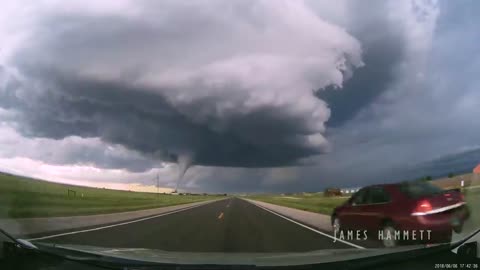 Storm chasing dashcam: Tornado crossing the highway! Laramie, Wyoming