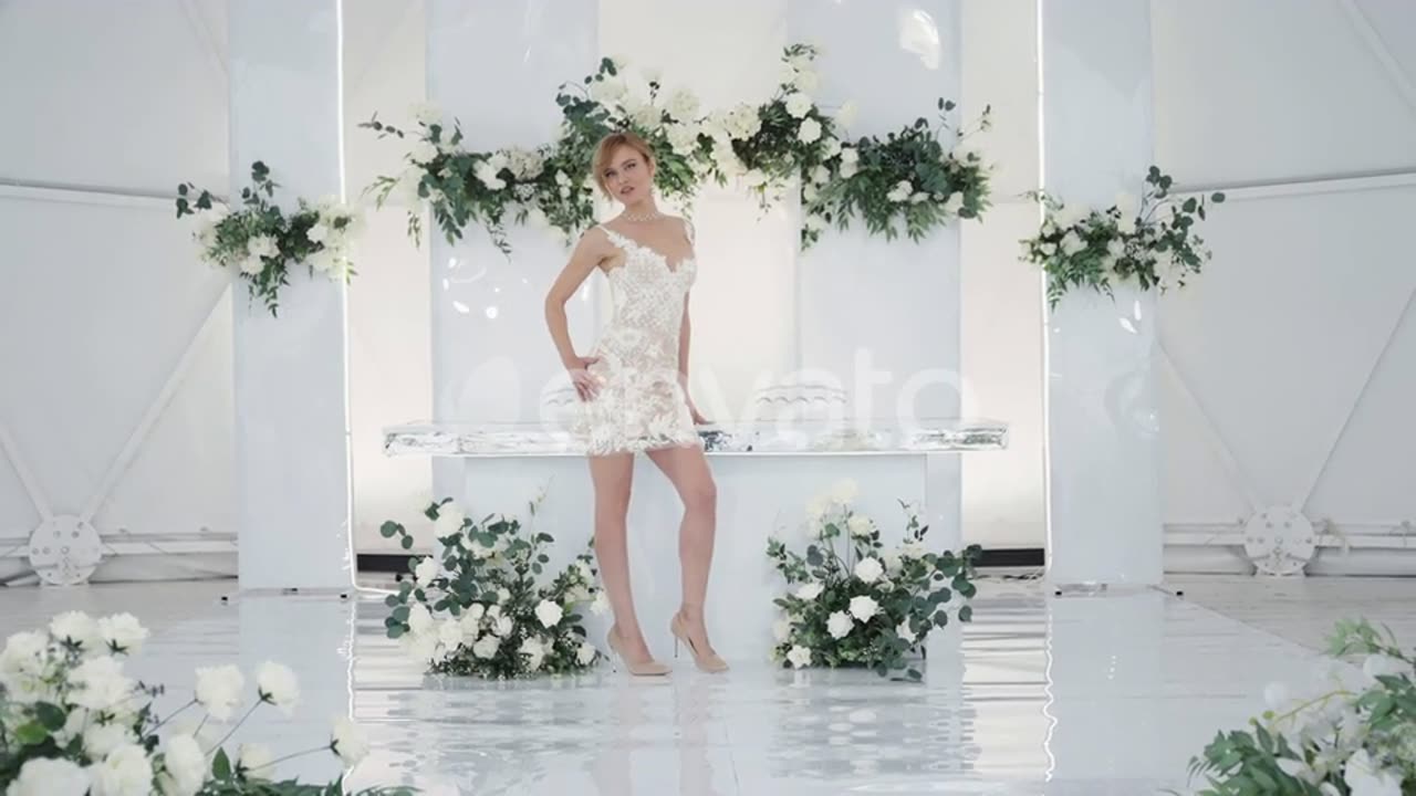 A Beautiful Model Wedding in a White Dress on poses Against backdrop of a Beautiful design