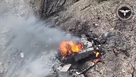 Russian soldiers try to hide under their disabled tank