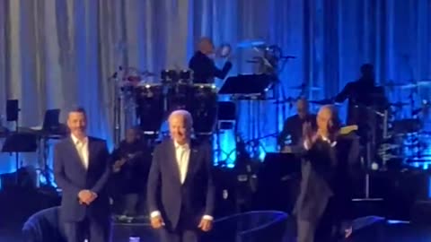 Biden freezes before Obama grabs his arm and leads him off stage