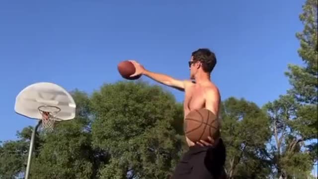 Guy Balancing on Slackline Shoots Two Balls Into the Basket