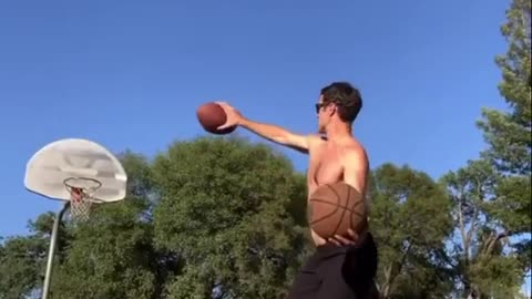 Guy Balancing on Slackline Shoots Two Balls Into the Basket