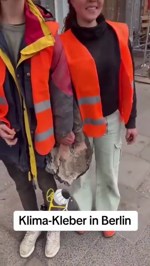 Climate activists glue hands to asphalt