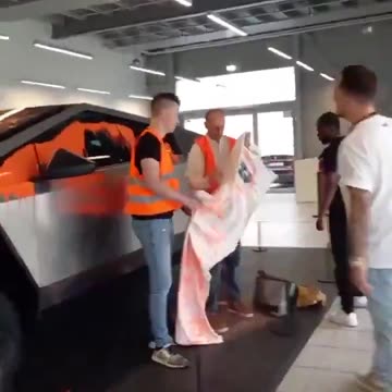 Activists throw orange paint over a Telsa Cybertuck