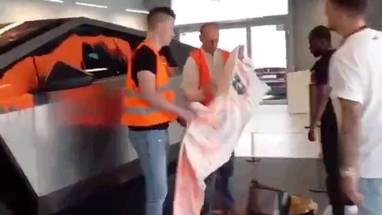 Activists throw orange paint over a Telsa Cybertuck