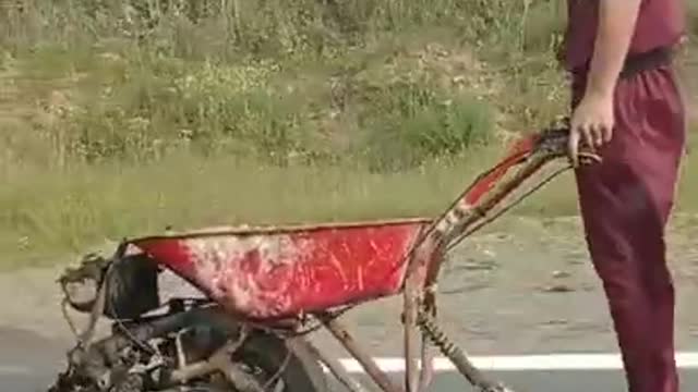 Man Amuses Passerby While Riding Makeshift Engine Powered Wheelbarrow