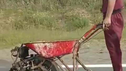 Man Amuses Passerby While Riding Makeshift Engine Powered Wheelbarrow