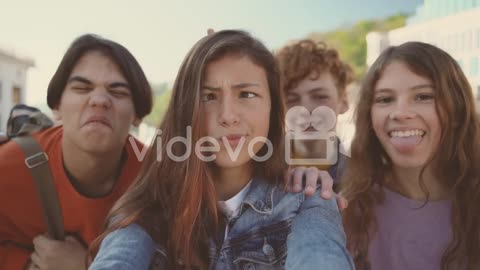 A Group Of Teenagers With Two Girls And Two Boys Take A Funny Selfie 1