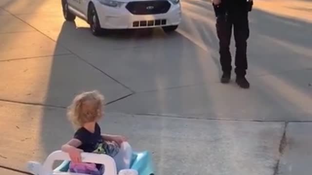 Neighbourhood Police Officer Jokingly Pulls Over Toddler While She Drives Toy Cat