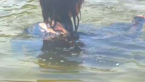 Cute girl swimming in river