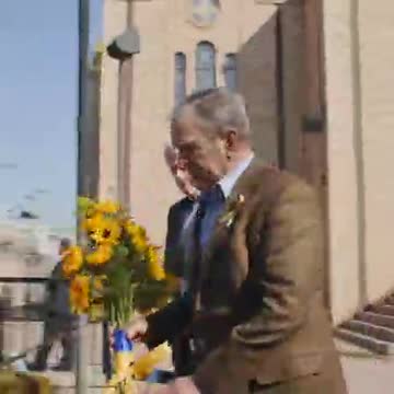 Former Presidents Bill Clinton And George W. Bush Lay Flowers At A Ukrainian Church