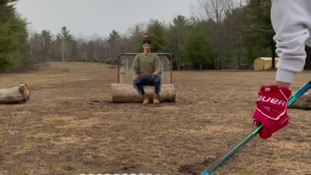 Guy Makes Fantastic Hockey Trick Shot by Hitting Apple on Friend's Head With Puck