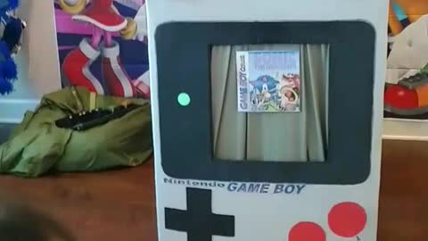 Nunchuks throw game through the Gameboy prop at a birthday party with blue hedgehog sonic mascot