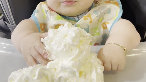 Baby Confused by First Encounter With Whipped Cream