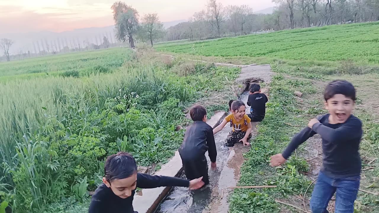 Kids Taking bath in the stream in a remote village of Pakistan