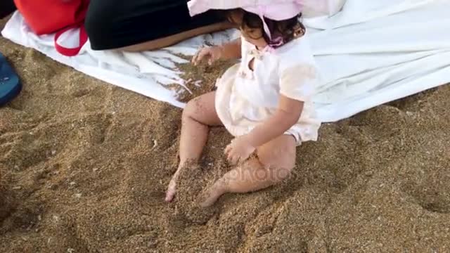 Close Beautiful Baby Girl Pink Dress Hat Playing Brown Sand