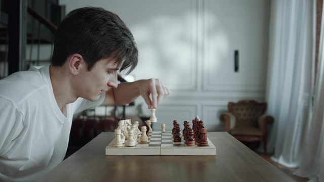 A Man Playing Chess Game Alone Changing Sides Every Move Made