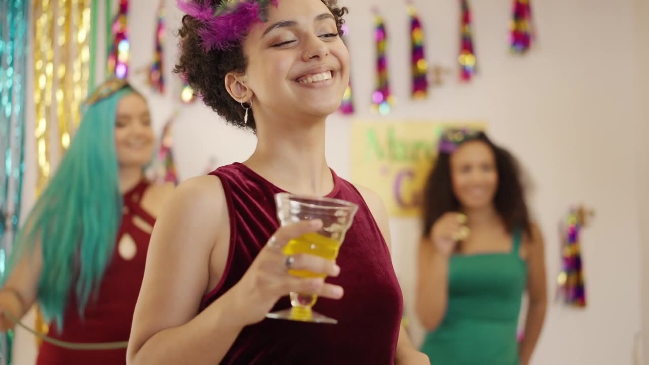 A women dancing while holding a drink