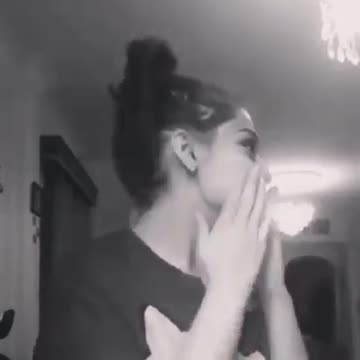 Young girl singing while her mother gives her instruction on how to sing