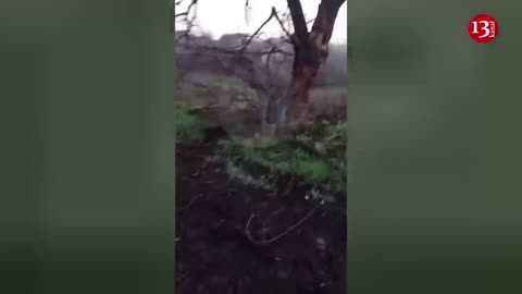 Ukrainian troops advancing on foot on Bakhmut road, equipment and vehicles scattered along roadside