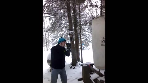 Canadian man in turtleneck sweater hits heavybag