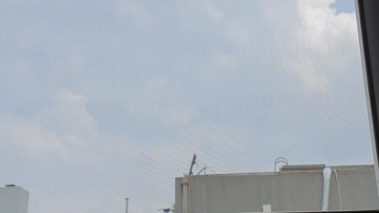 The sky outside the window and towels