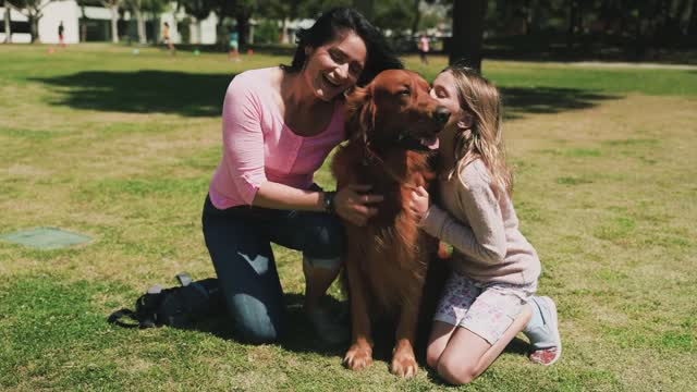 Mother and Daughter Petting a Dog