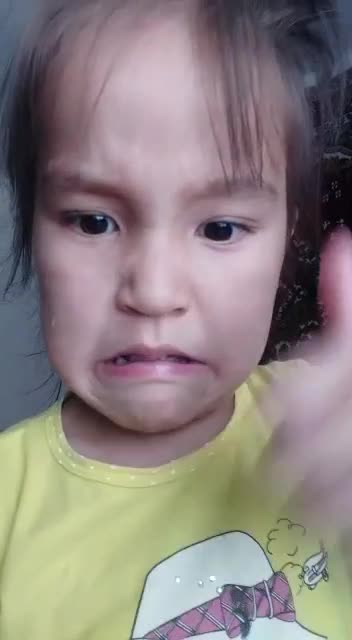 Little girl is teaching how to eat bread