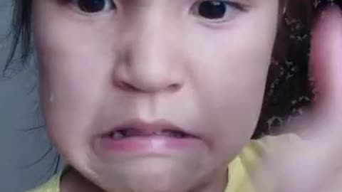 Little girl is teaching how to eat bread