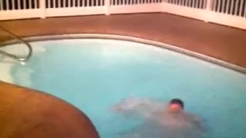 Guy trying to jump from one side of the pool to the other