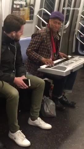 Man sings purple rain on subway train