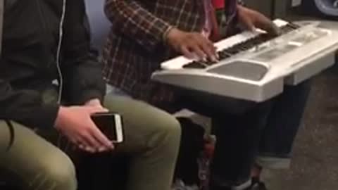 Man sings purple rain on subway train