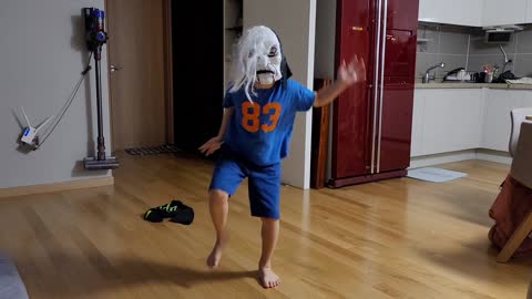 a child dancing in a mask on his face