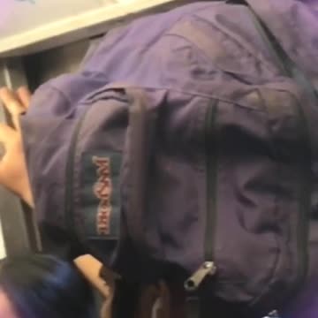 Man with bag on head on subway