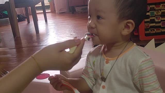 A baby who tries to eat but doesn't.