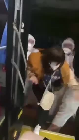 China, Here people are forced to board a bus that takes them to a quarantine camp.