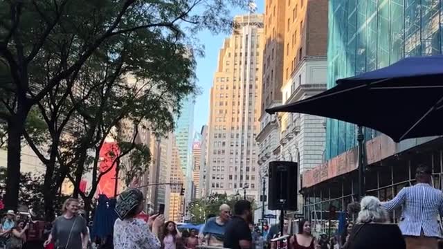 Lots of people dancing in Manhattan Square