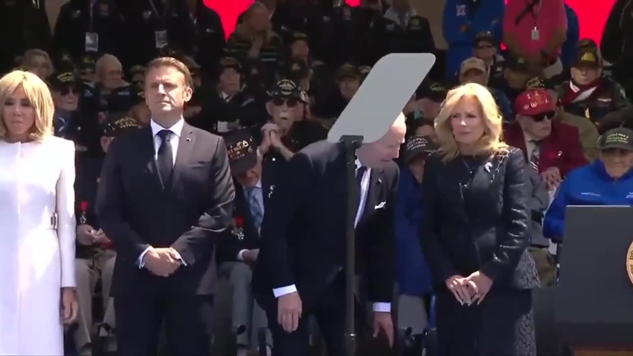 At a D-Day anniversary event, President Biden tries to sit on a chair that doesn’t exist.