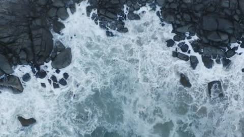 Top aerial shot of seashore with rocks