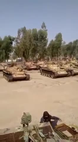 Taliban showing a large yard full of American tanks