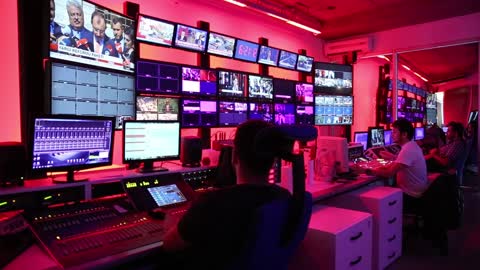 Men working in the control room of a broadcasting network company